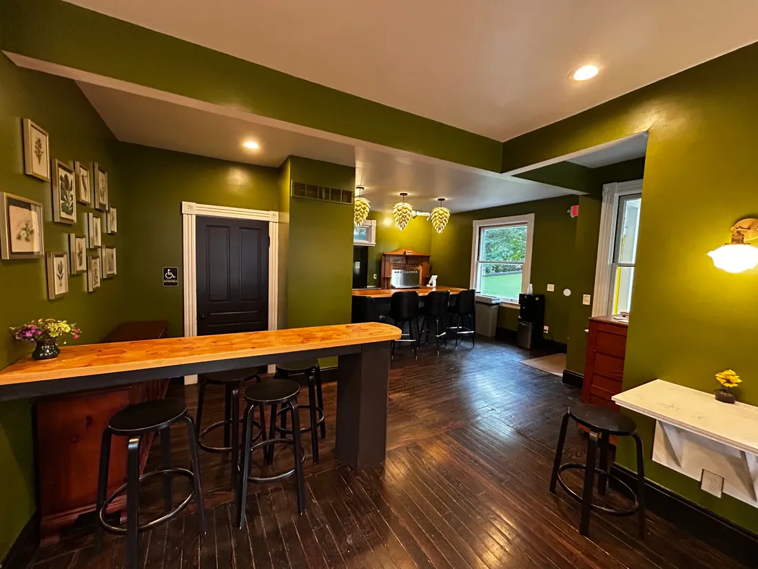 Bar top and stools beside the botanical print wall
