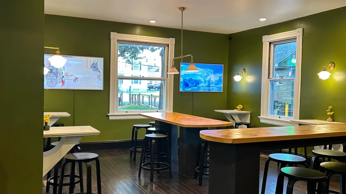High-top tables and stools by the windows