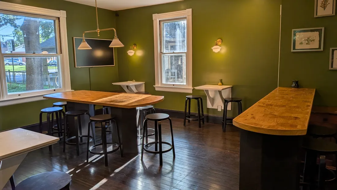 High-tops and bar seating in the sunlit dining room